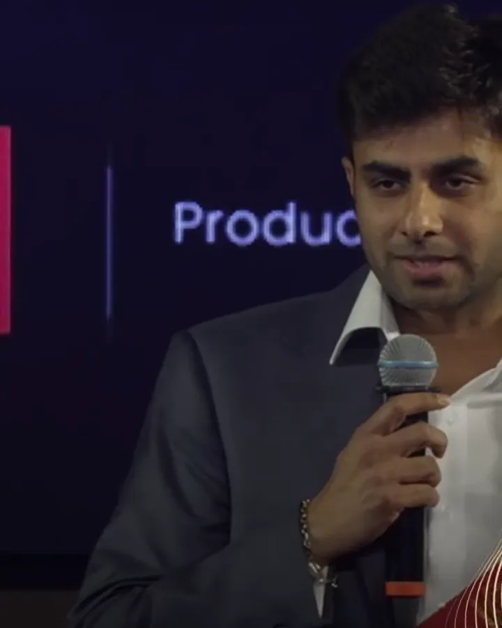 Maqsood Muhammed speaking into a microphone at Icons of the UAE – Season 3
